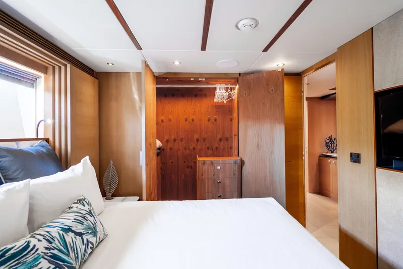 One More Time Yacht Photos Pics Luxurious bedroom interior on 2020 Horizon FD80 yacht, featuring elegant wood finishes and modern decor.