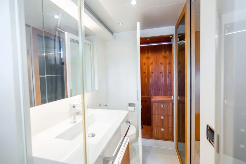 One More Time Yacht Photos Pics Modern bathroom interior on 2020 Horizon FD80 yacht, featuring sleek design and wooden accents.