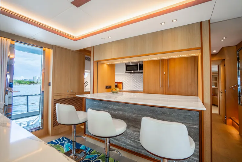 One More Time Yacht Photos Pics Luxurious 2020 Horizon FD80 yacht interior with modern kitchen and elegant seating.