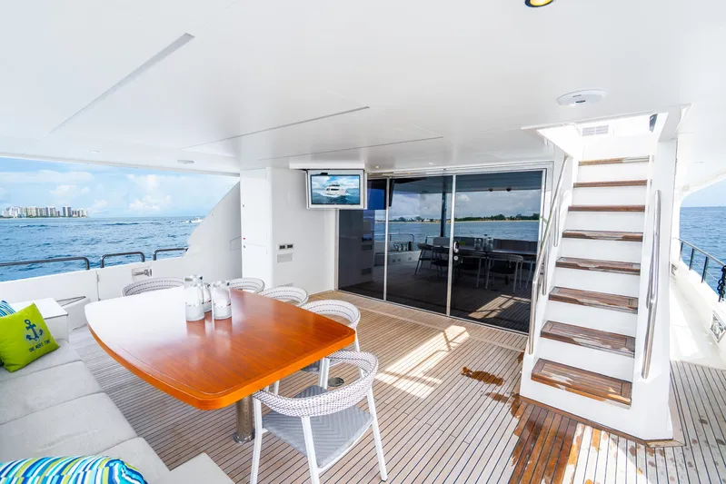 One More Time Yacht Photos Pics Luxurious 2020 Horizon FD80 yacht deck with dining area, ocean view, and modern amenities.
