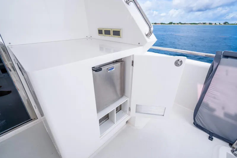 One More Time Yacht Photos Pics Luxury yacht Horizon FD80 2020 model with open storage compartment and ocean view.