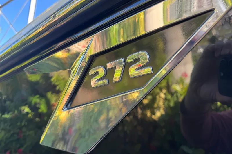  Yacht Photos Pics Close-up of 2021 Blackfin 272 CC boat emblem with reflective chrome finish.