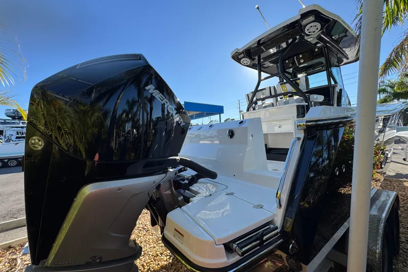  Yacht Photos Pics 2021 Blackfin 272 CC boat with Mercury engine, docked under clear blue sky.