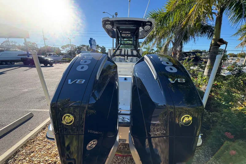  Yacht Photos Pics 2021 Blackfin 272 CC boat with twin 600 V8 Verado engines, parked under palm trees.