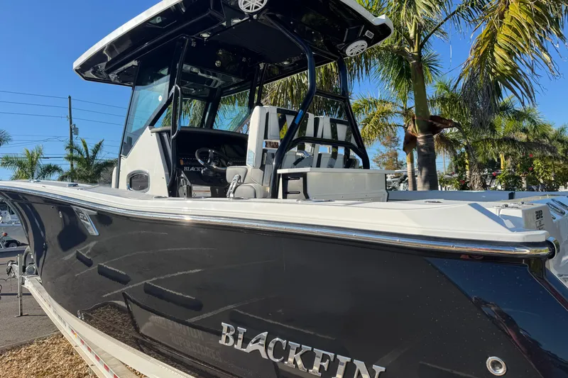  Yacht Photos Pics 2021 Blackfin 272 CC boat with sleek design, parked near palm trees.