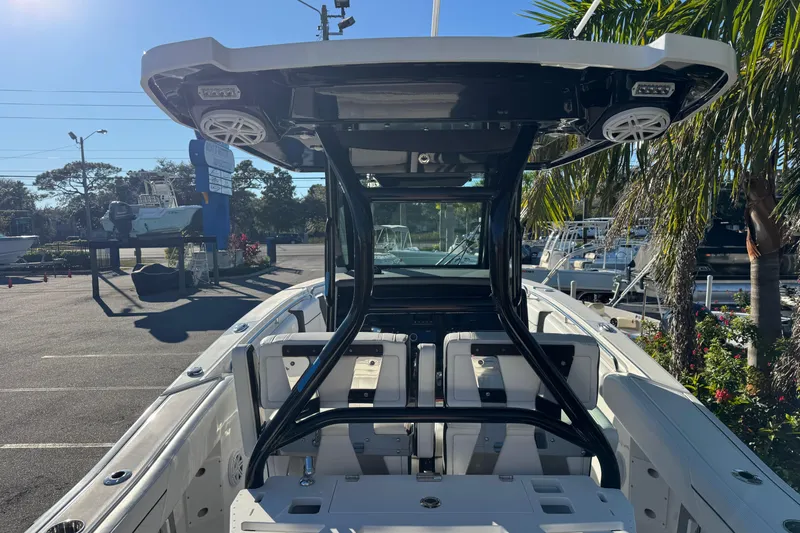  Yacht Photos Pics 2021 Blackfin 272 CC boat interior with seating and overhead speakers in a sunny marina.