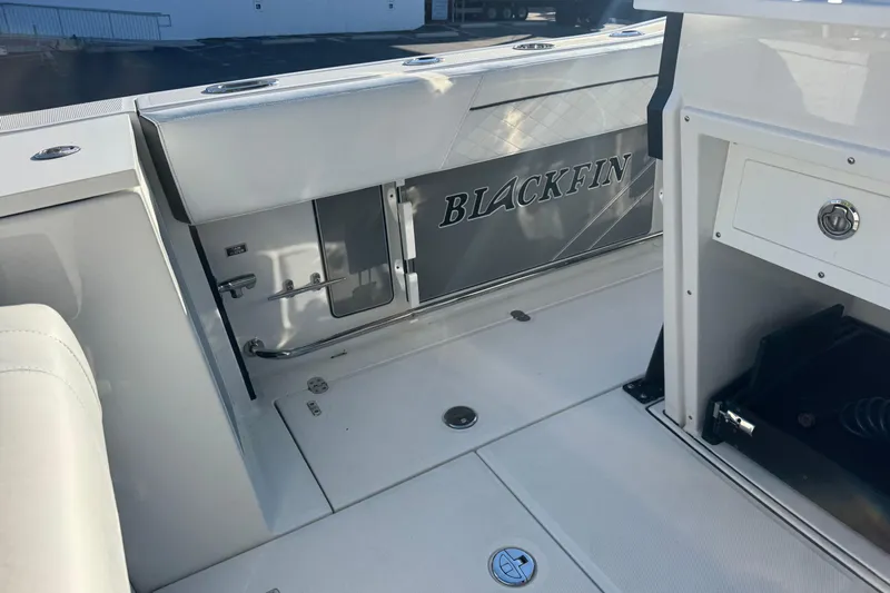  Yacht Photos Pics 2021 Blackfin 272 CC boat interior with sleek white seating and storage compartments.