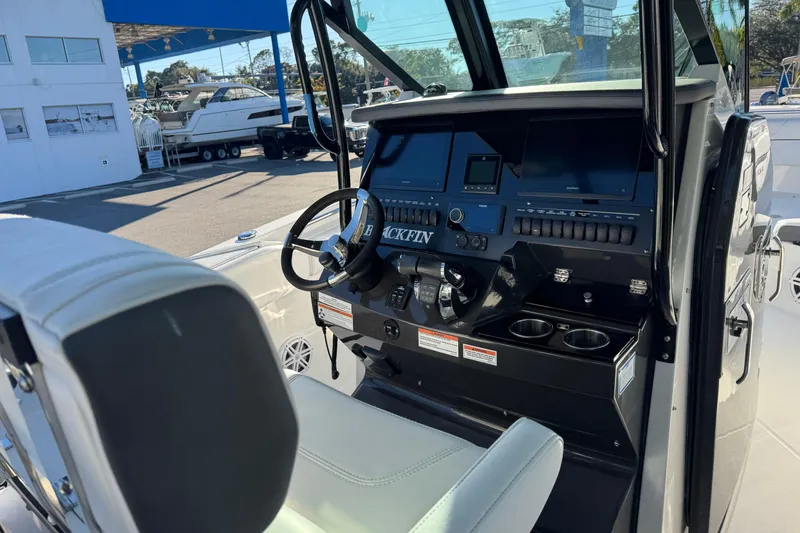  Yacht Photos Pics 2021 Blackfin 272 CC boat console with steering wheel and navigation displays.