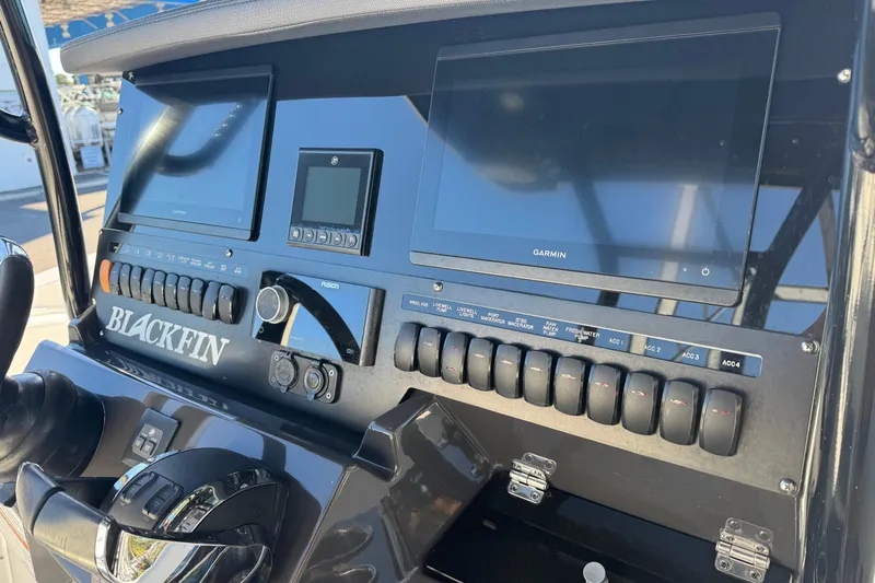  Yacht Photos Pics 2021 Blackfin 272 CC boat dashboard with Garmin displays and control switches.