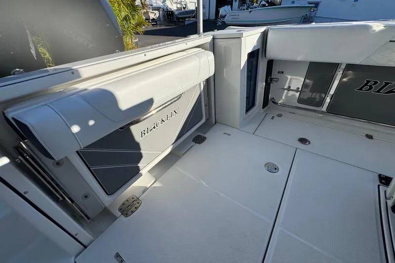  Yacht Photos Pics 2021 Blackfin 272 CC boat interior with seating and storage compartments.
