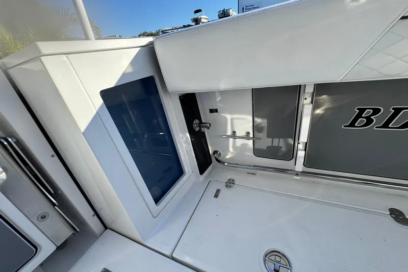  Yacht Photos Pics 2021 Blackfin 272 CC boat interior with storage compartments and sleek design.