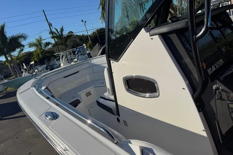  Yacht Photos Pics 2021 Blackfin 272 CC boat, sleek design, docked with palm trees in the background.