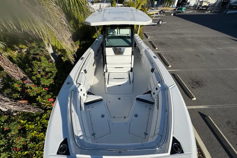  Yacht Photos Pics 2021 Blackfin 272 CC boat, aerial view, parked near lush greenery and empty parking spaces.
