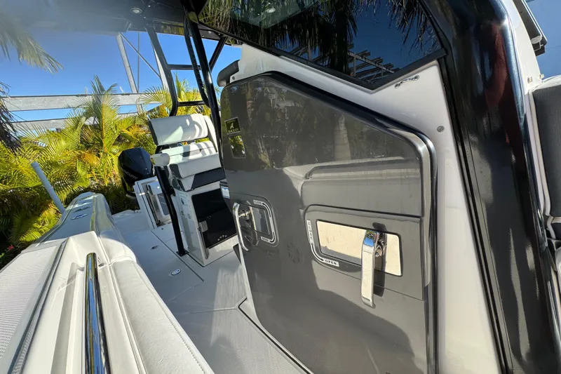  Yacht Photos Pics 2021 Blackfin 272 CC boat interior with seating and storage, surrounded by tropical plants.