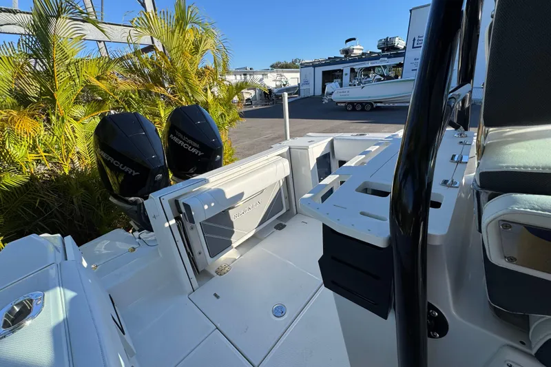  Yacht Photos Pics 2021 Blackfin 272 CC boat with dual Mercury engines, docked near tropical plants.