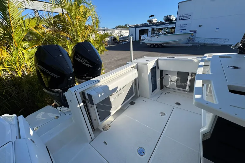  Yacht Photos Pics 2021 Blackfin 272 CC boat with dual Mercury engines, docked near service area.