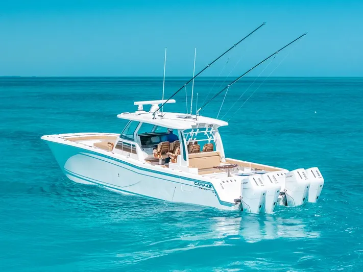  Yacht Photos Pics 2025 Caymas 44 CT boat cruising on clear blue ocean waters.