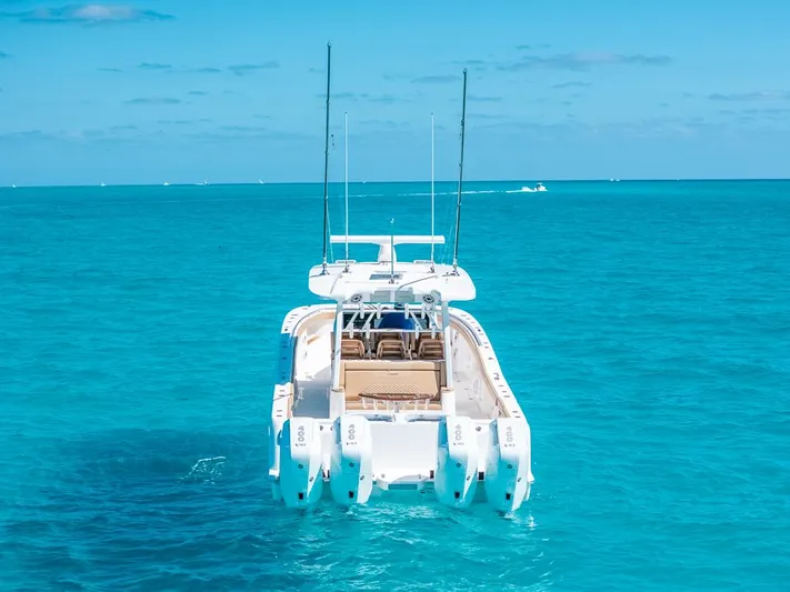  Yacht Photos Pics 2025 Caymas 44 CT boat on clear turquoise water, rear view.