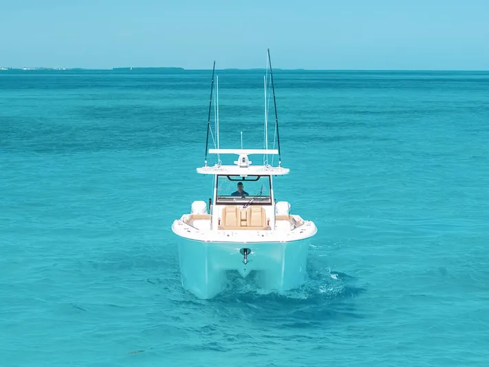  Yacht Photos Pics 2025 Caymas 44 CT boat cruising in clear turquoise waters.