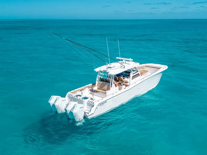  Yacht Photos Pics 2025 Caymas 44 CT boat cruising on clear blue ocean waters.