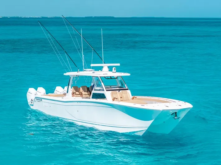  Yacht Photos Pics 2025 Caymas 44 CT boat cruising on clear turquoise waters.
