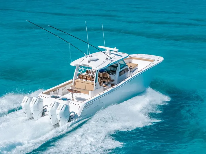  Yacht Photos Pics 2025 Caymas 44 CT boat cruising on clear turquoise water.