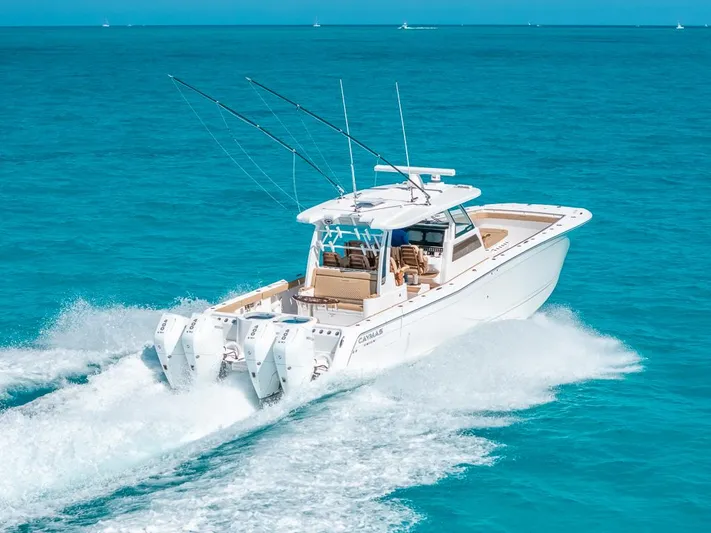  Yacht Photos Pics 2025 Caymas 44 CT boat cruising on clear blue ocean waters.