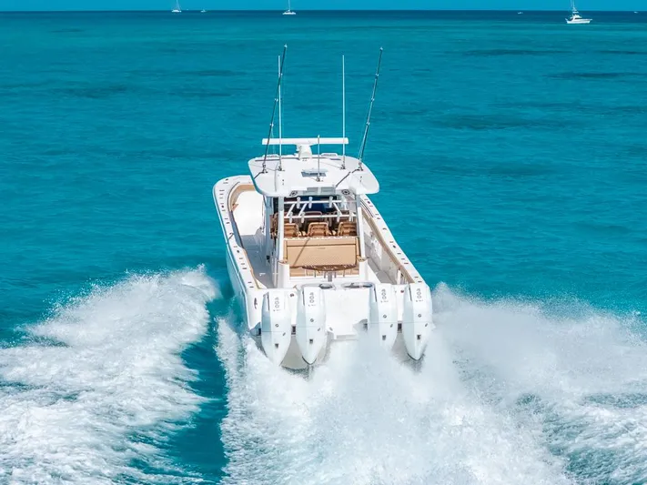  Yacht Photos Pics 2025 Caymas 44 CT boat cruising on clear turquoise waters.