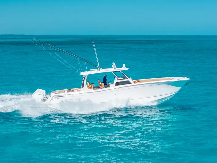  Yacht Photos Pics 2025 Caymas 44 CT boat cruising on clear blue ocean waters.