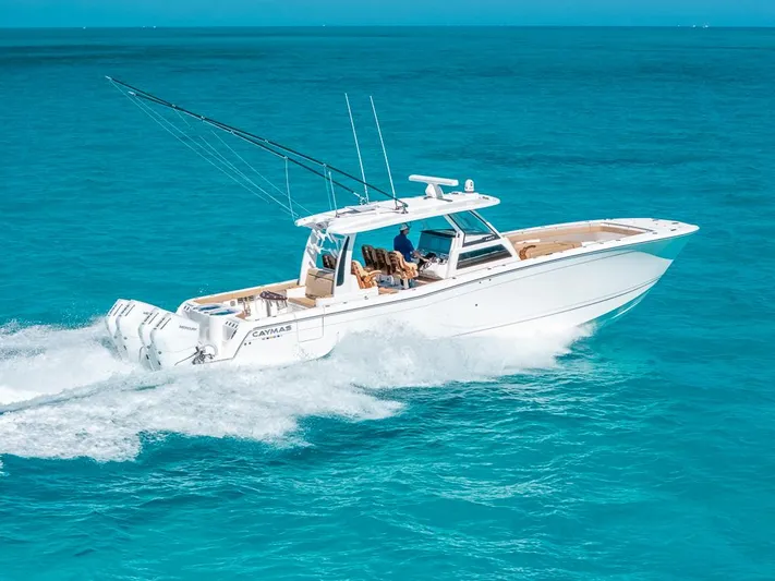  Yacht Photos Pics 2025 Caymas 44 CT boat cruising on clear blue ocean waters.