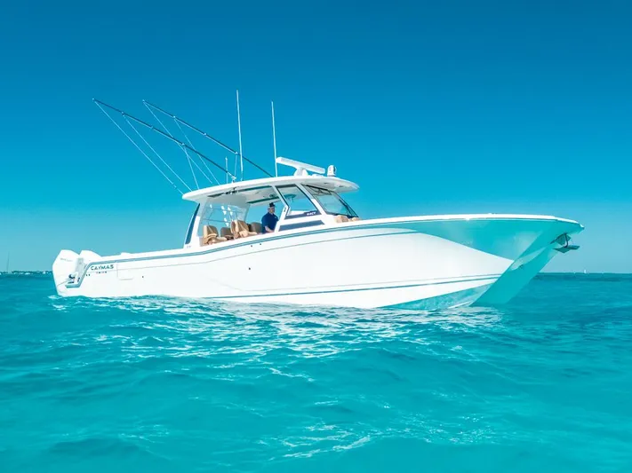  Yacht Photos Pics 2025 Caymas 44 CT boat cruising on clear blue water under a bright sky.