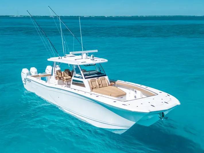  Yacht Photos Pics 2025 Caymas 44 CT boat cruising on clear turquoise waters.