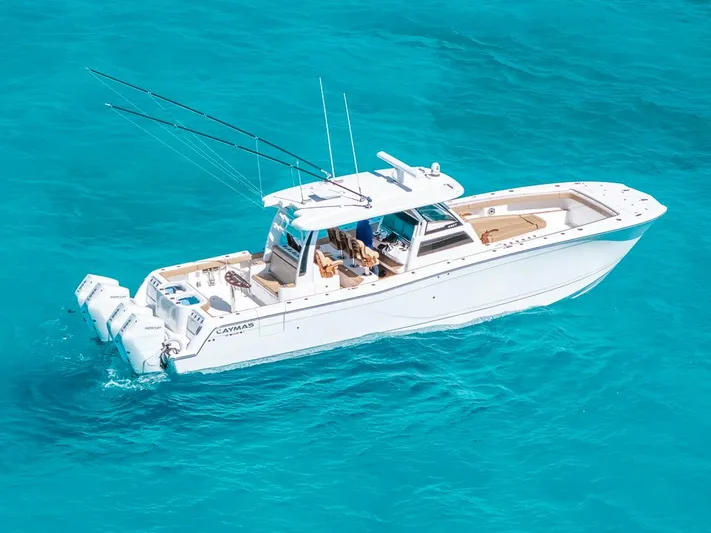  Yacht Photos Pics 2025 Caymas 44 CT boat cruising on clear turquoise water.
