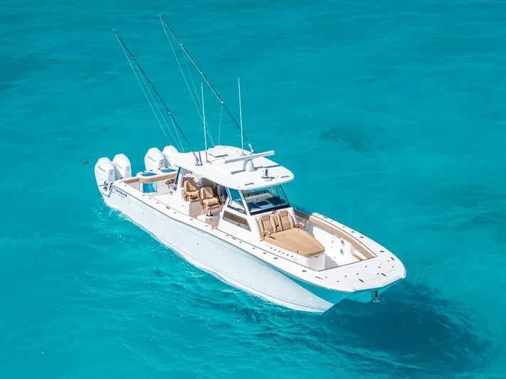  Yacht Photos Pics 2025 Caymas 44 CT boat cruising on clear turquoise water.