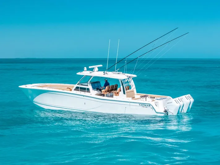  Yacht Photos Pics 2025 Caymas 44 CT boat cruising on clear blue ocean waters.