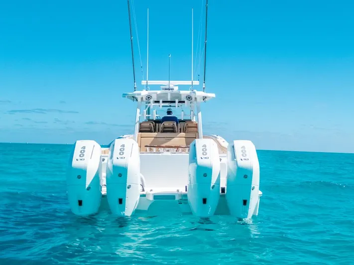  Yacht Photos Pics 2025 Caymas 44 CT boat with multiple engines on clear blue water.