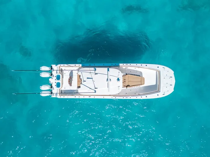  Yacht Photos Pics Aerial view of 2025 Caymas 44 CT boat on clear turquoise water.