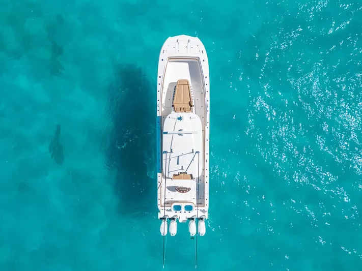  Yacht Photos Pics Aerial view of 2025 Caymas 44 CT boat on clear turquoise water.