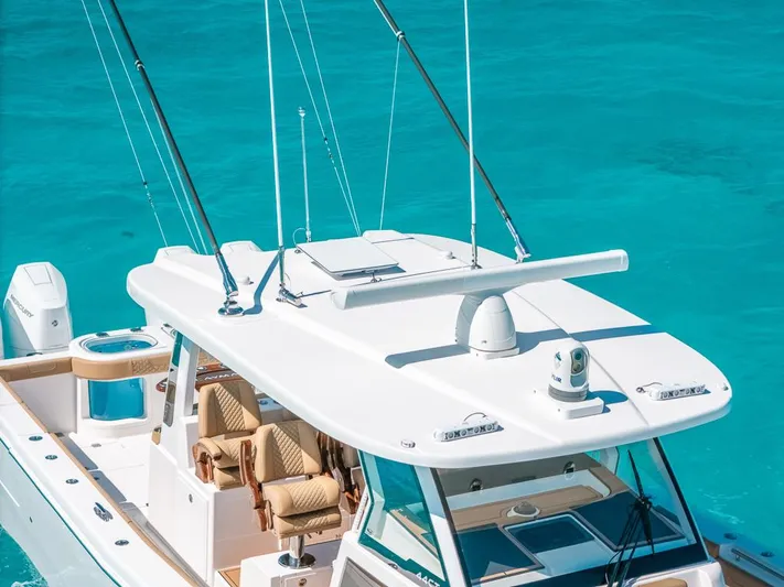  Yacht Photos Pics 2025 Caymas 44 CT boat on turquoise water, featuring a sleek design and modern amenities.