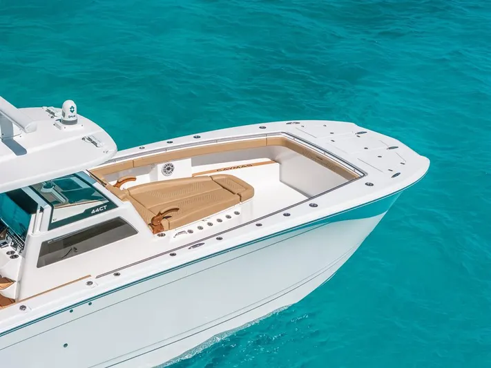  Yacht Photos Pics 2025 Caymas 44 CT boat on clear turquoise water, showcasing sleek design and spacious deck.