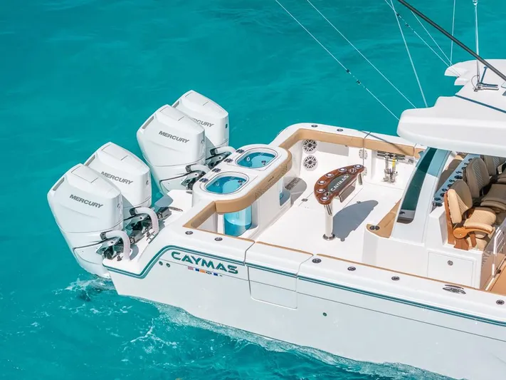  Yacht Photos Pics 2025 Caymas 44 CT boat with Mercury engines on turquoise water.