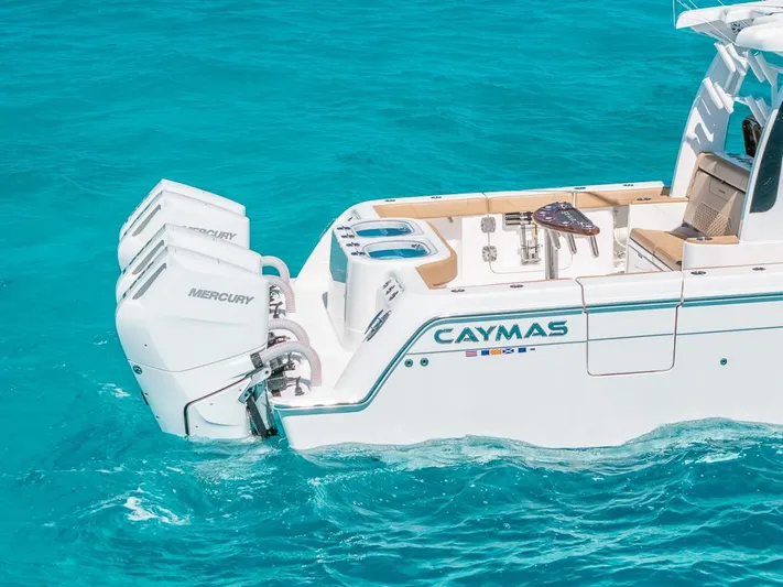  Yacht Photos Pics 2025 Caymas 44 CT boat with Mercury engines on turquoise water.