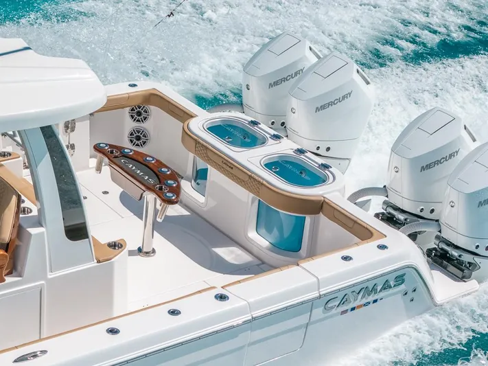  Yacht Photos Pics 2025 Caymas 44 CT boat with Mercury engines cruising on clear blue water.