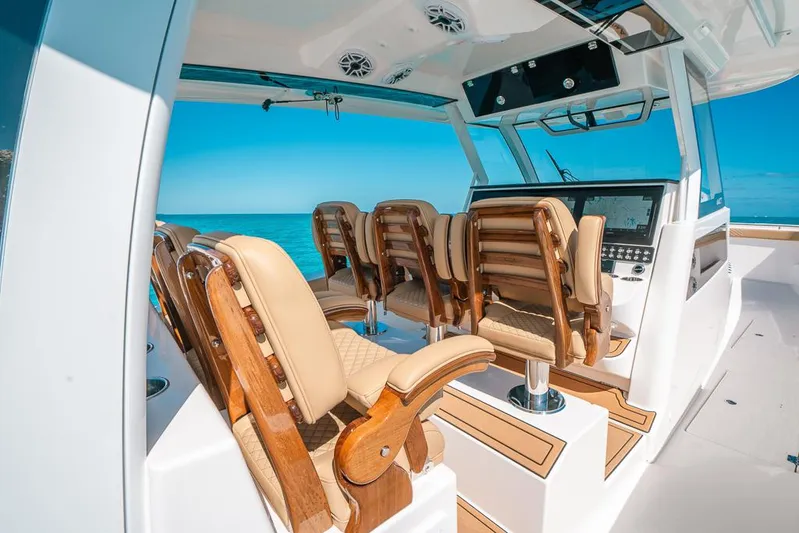  Yacht Photos Pics Interior of 2025 Caymas 44 CT boat with wooden seating and modern dashboard.