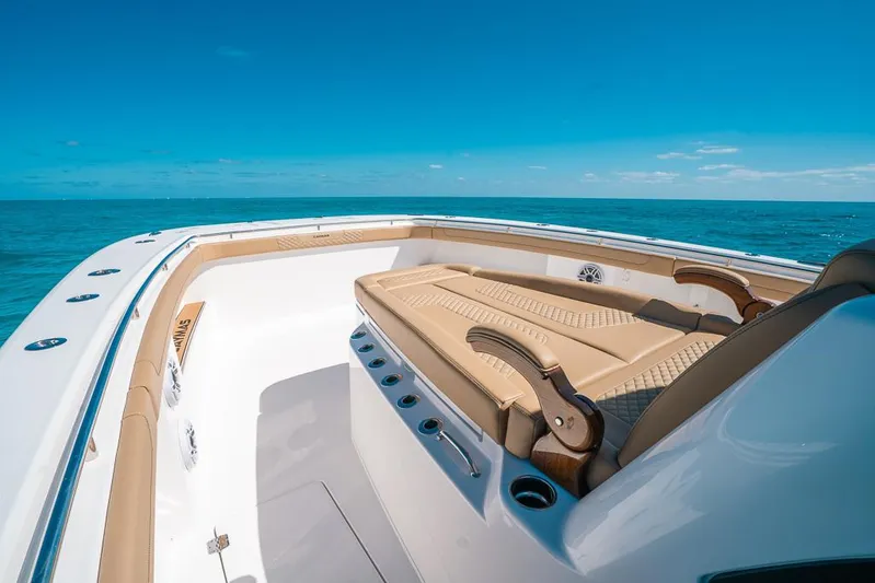  Yacht Photos Pics 2025 Caymas 44 CT boat with luxurious seating, cruising on open ocean.