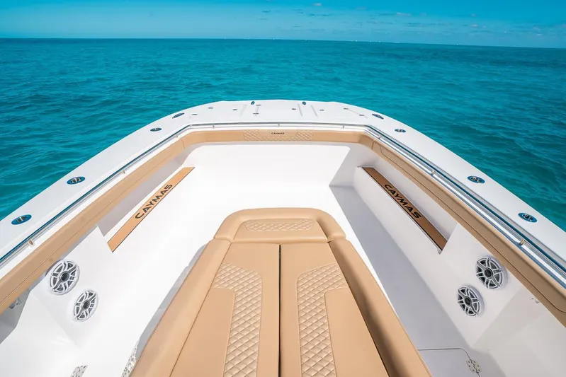  Yacht Photos Pics Luxury Caymas 44 CT boat deck with tan seating, 2025 model, on clear blue ocean.