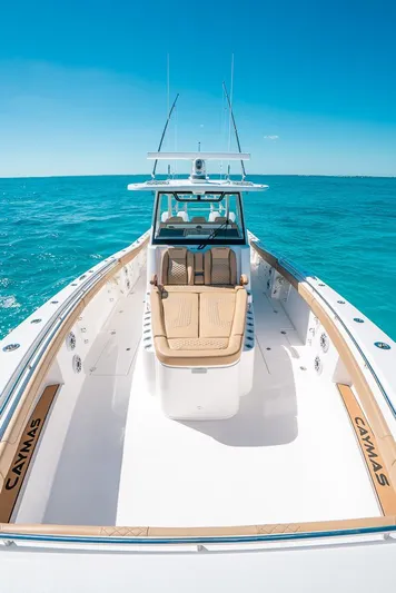  Yacht Photos Pics 2025 Caymas 44 CT boat cruising on clear blue ocean waters.