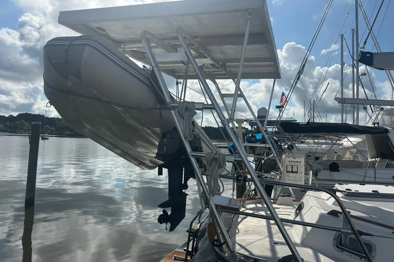  Yacht Photos Pics Sailboat Tayana 48 (1995) with dinghy and solar panels at marina.