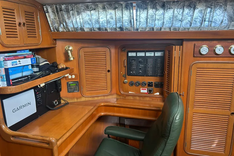  Yacht Photos Pics Navigation station of 1995 Tayana 48 yacht with control panel and books.