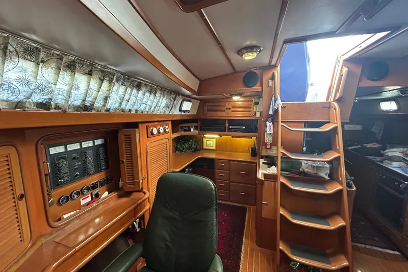  Yacht Photos Pics Interior of a 1995 Tayana 48 yacht featuring wooden cabinetry and a navigation station.